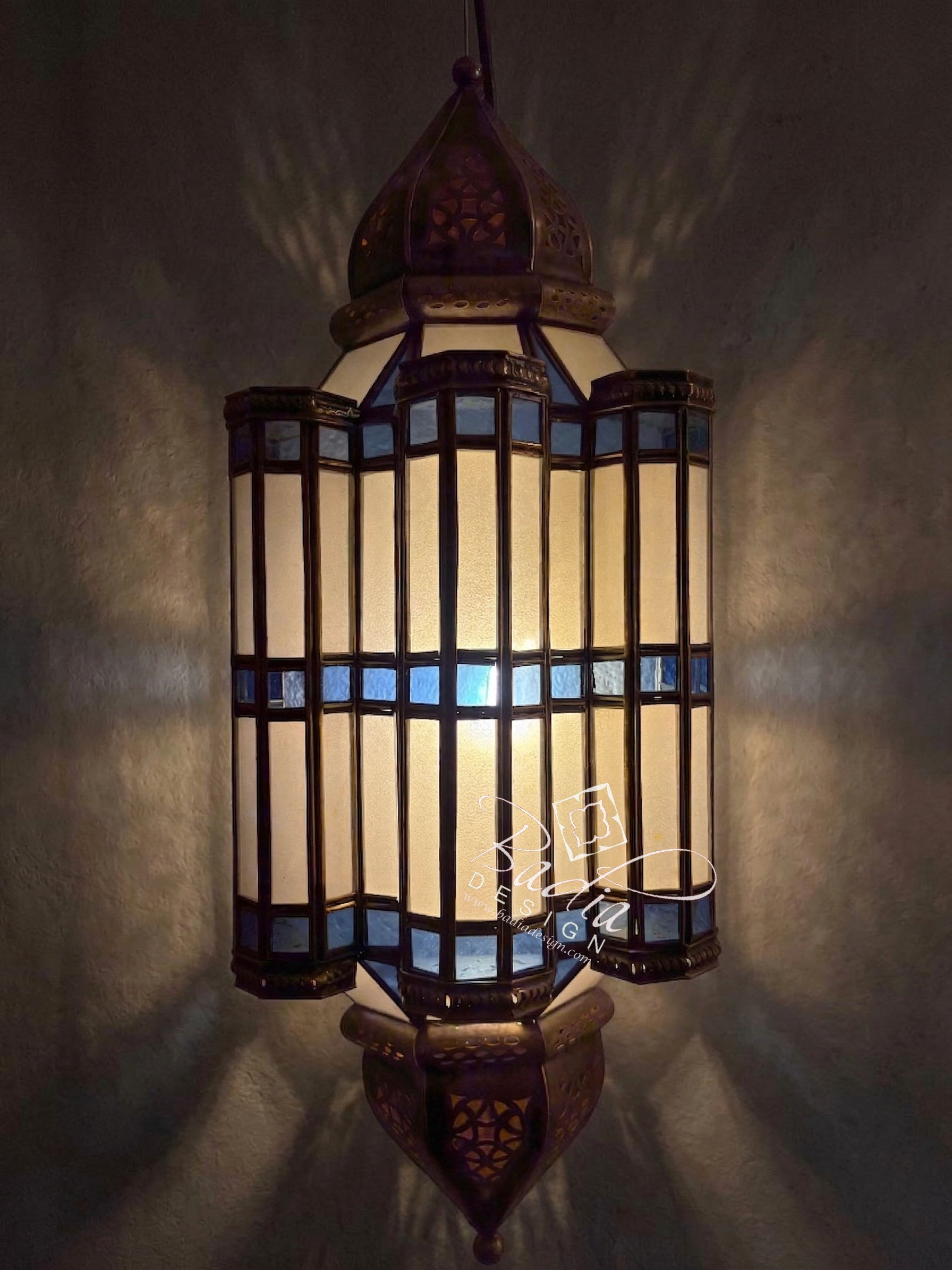 Decorative hanging lamp with intricate design on a dark background