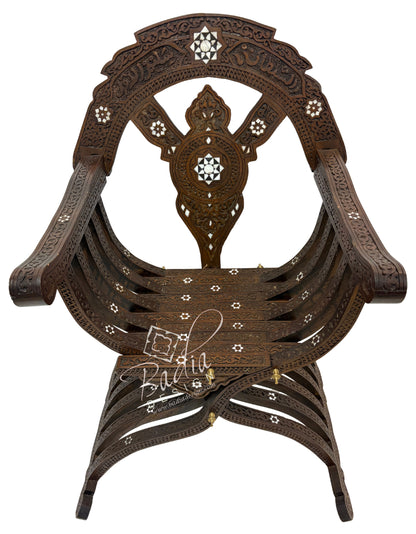 Decorative wooden chair with intricate designs on a white background