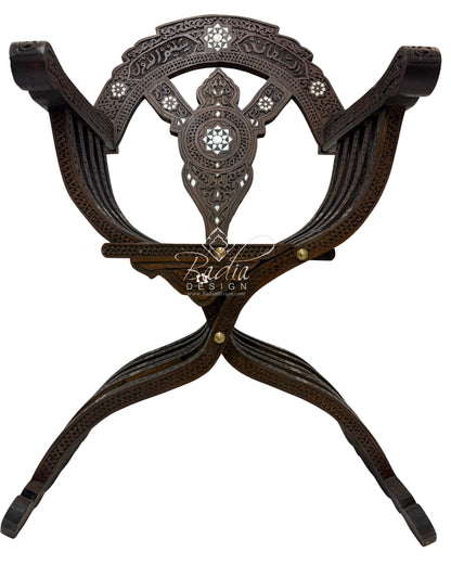 Decorative metal stand with intricate design on a white background, featuring the brand &