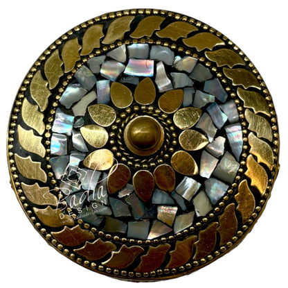 Top View of Decorative circular object with mosaic design and gold accents on a white background