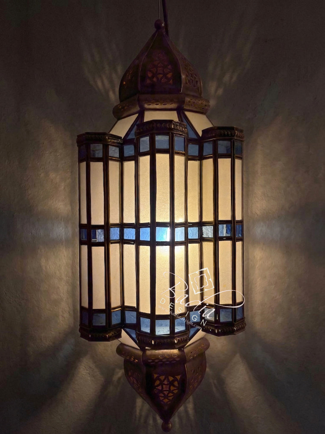 Decorative hanging lamp with intricate design on a dark background