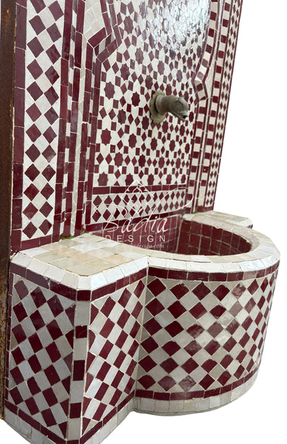 Mosaic-tiled corner unit with geometric pattern, featuring the brand &