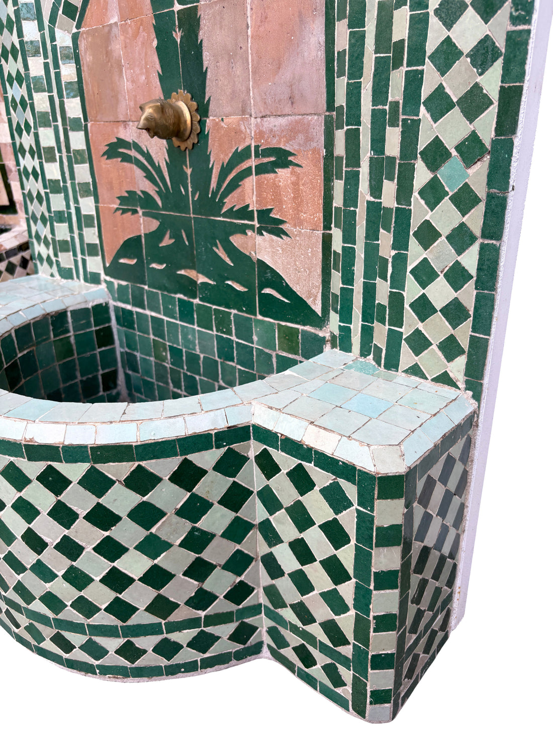 Mosaic tiled fountain with geometric patterns and a palm tree design.
