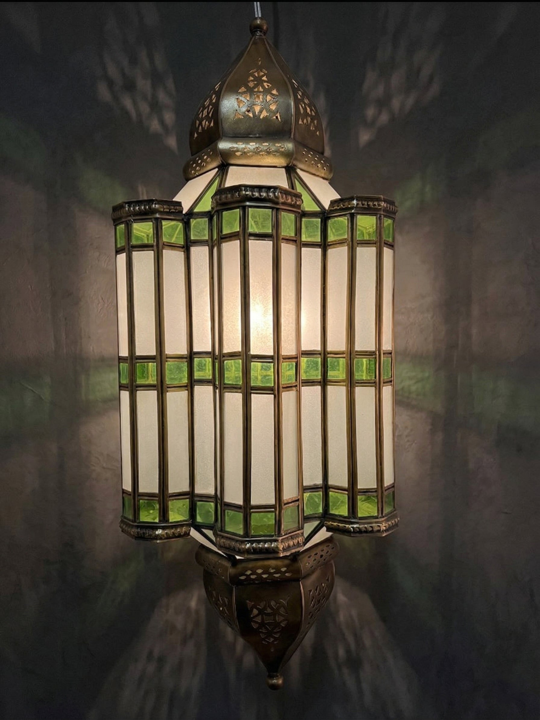 Decorative hanging lamp with stained glass design on a dark background