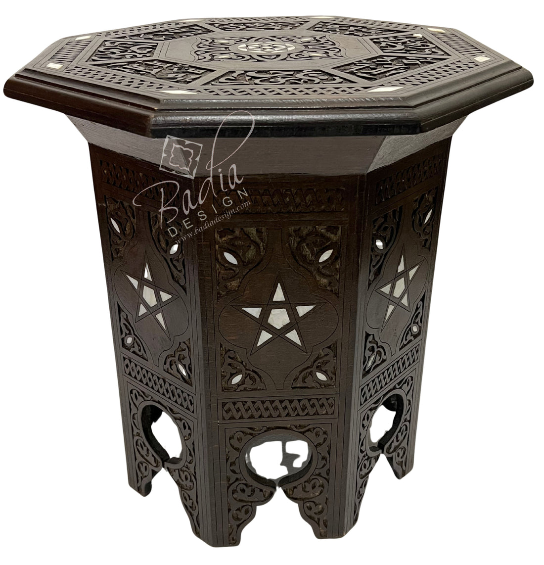 Decorative hexagonal side table with intricate patterns on a white background