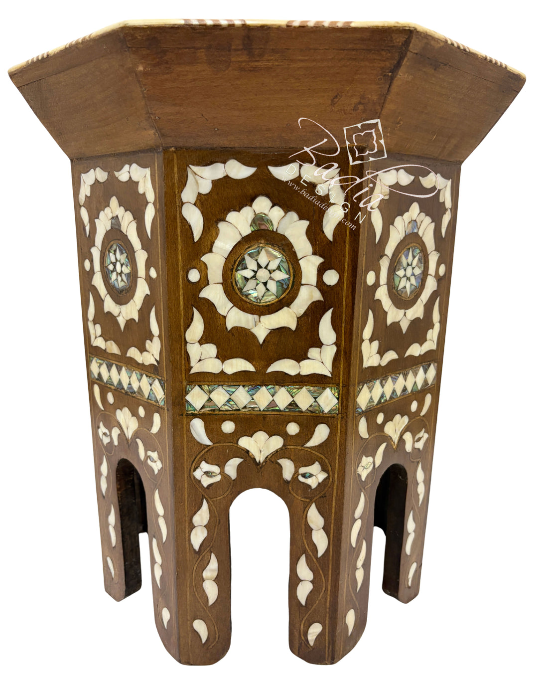 Decorative wooden stool with intricate carvings on a white background