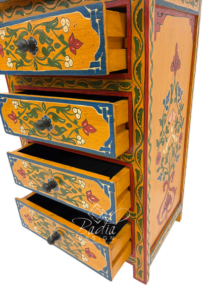 Decorative wooden chest of drawers with floral patterns on a white background