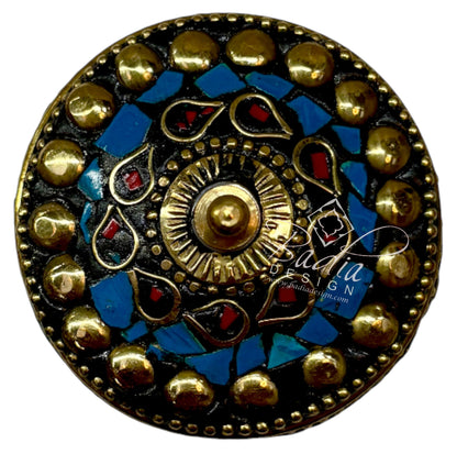 Decorative round object with gold and blue design with areal top view on a white background