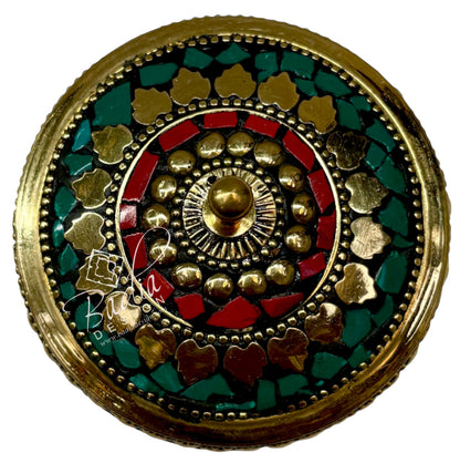 Aerial View of Decorative circular object with gold, red, and green colors on a white background