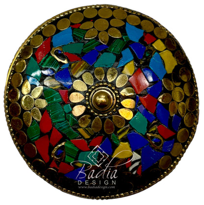 Top View Decorative circular object with mosaic design featuring gold, blue, green, and red colors on a white background.