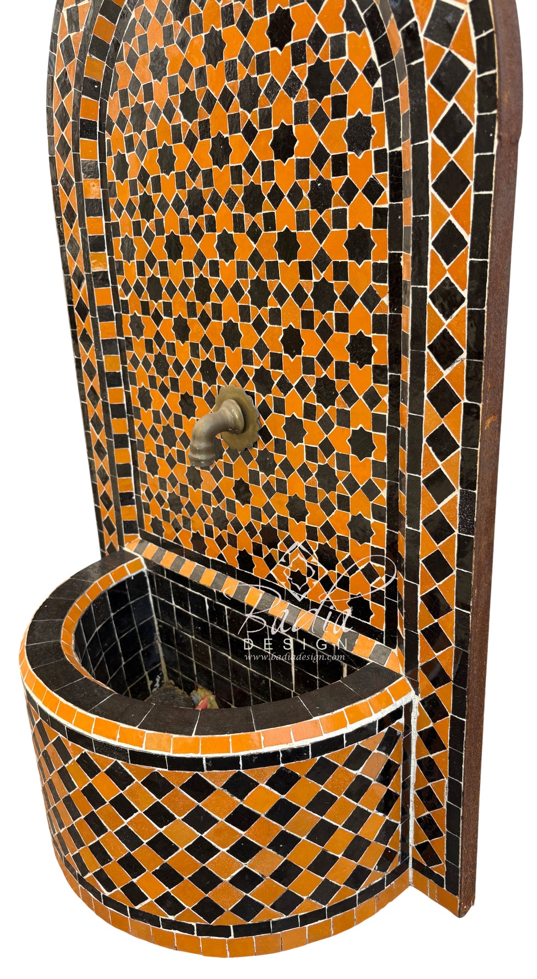 Mosaic wall fountain with orange and black pattern on a white background
