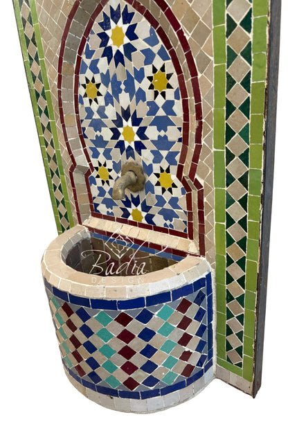 Decorative mosaic fountain with geometric patterns and colorful tiles.