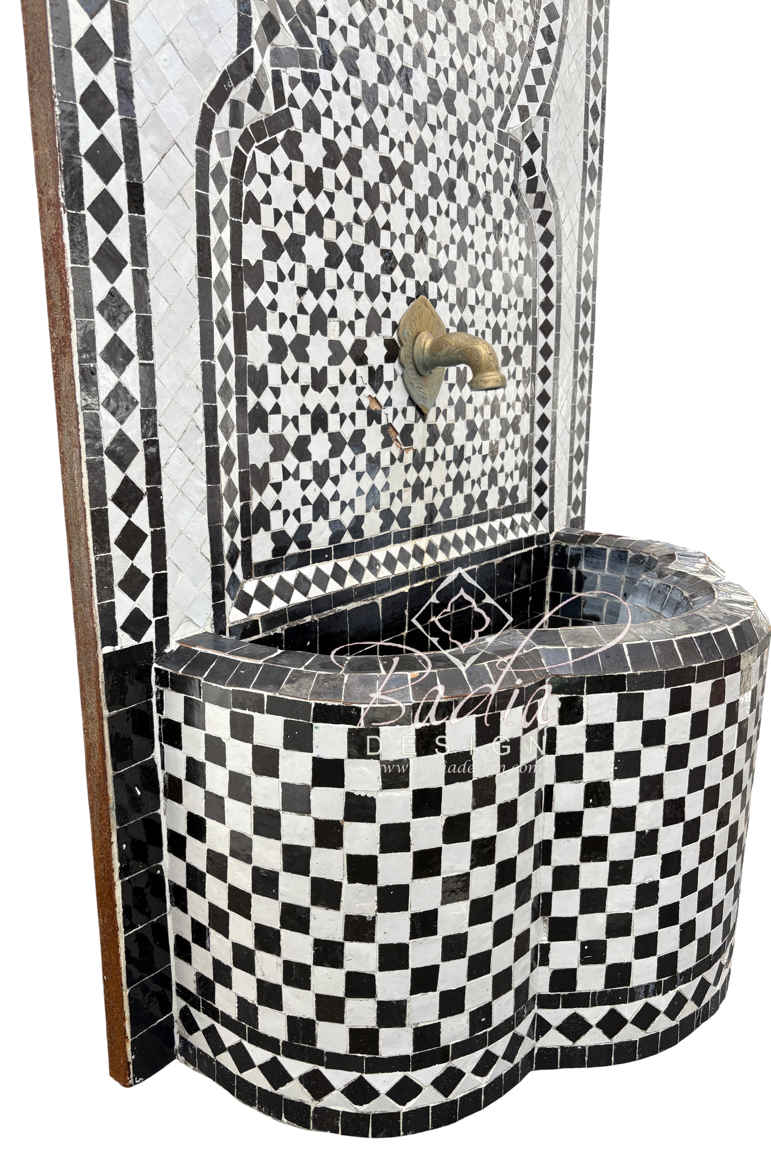 Black and white mosaic patterned water fountain with decorative design